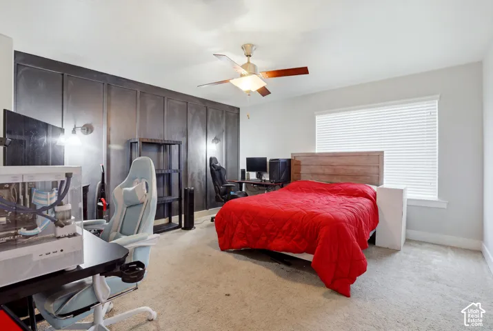 Accent wall featuring a paneled design and sconce lighting
