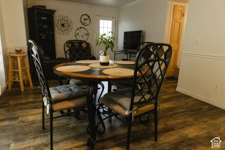 Wood-finish flooring with white baseboards