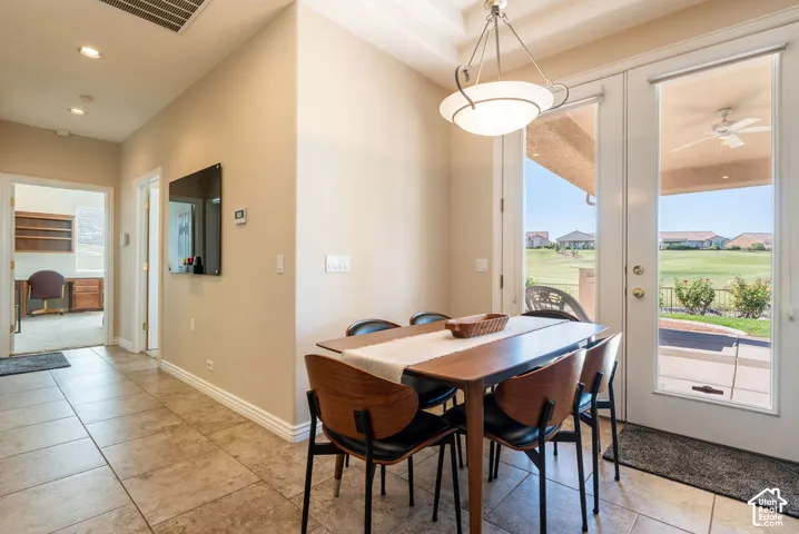 Patio access with dual French doors, overhead ceiling fan, and golf course frontage