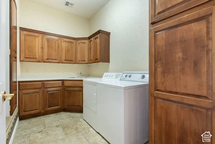 Built-in cabinetry with wood-finish doors, countertop with an integrated sink, and durable tile flooring
