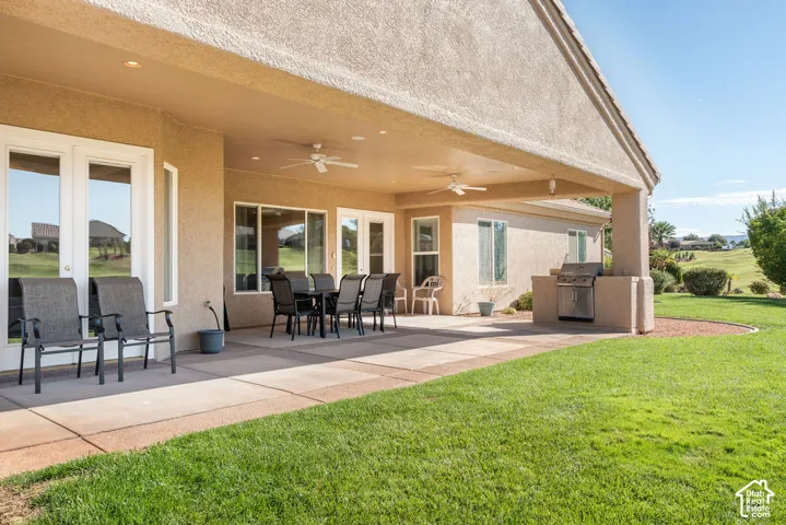 Covered patio with recessed lighting, integrated ceiling fans, and an outdoor cooking station