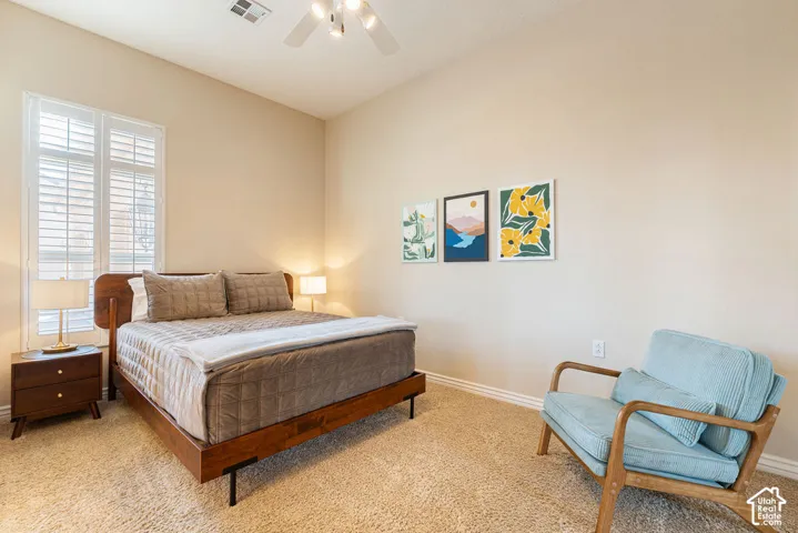 Recessed lighting, ceiling fan, carpeted flooring, window with plantation shutters, light-toned walls