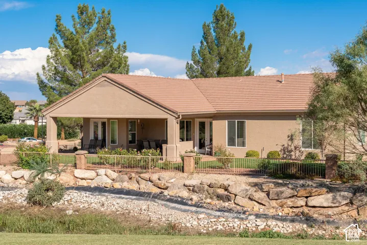 Covered patio with a tile roof, stucco exterior, and a fenced yard