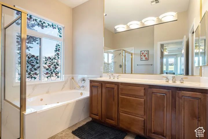 Dual vanity with wood-finish cabinetry and white countertops