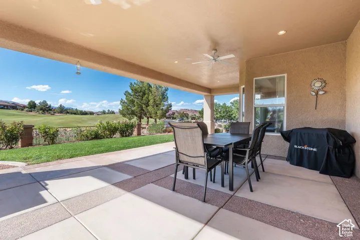 Covered patio featuring a ceiling fan, recessed lighting, and a textured exterior wall