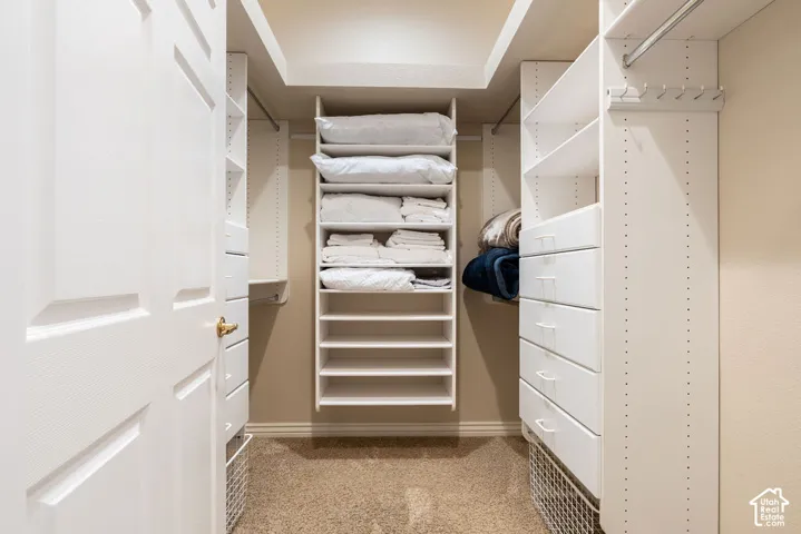Custom closet system featuring multiple shelves, integrated drawers, and hanging rods
