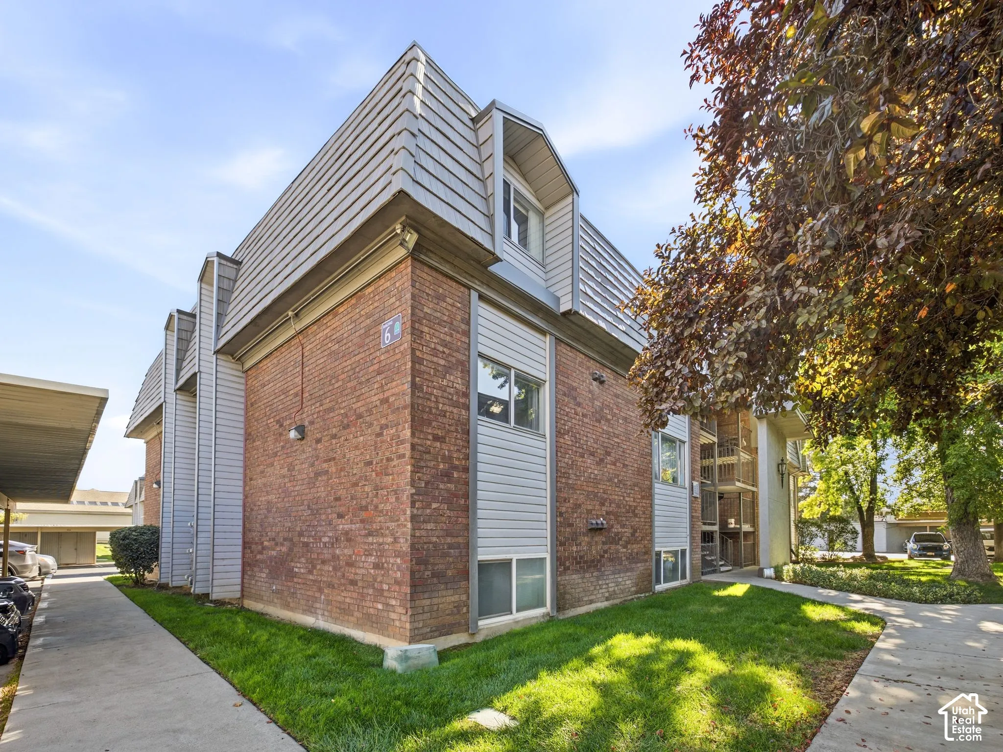 Brick exterior with gray siding and a mansard roof