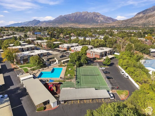Community amenities featuring a swimming pool, tennis court, and covered parking