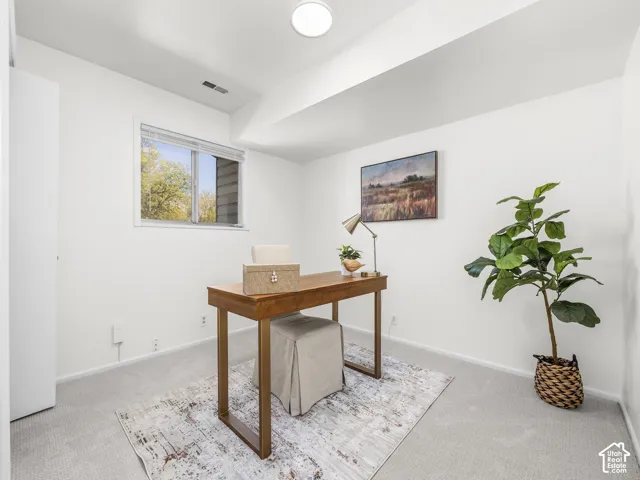 White walls with a single window and recessed ceiling lighting