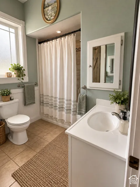 Bathroom featuring a white vanity with integrated sink, white medicine cabinet, and tiled flooring