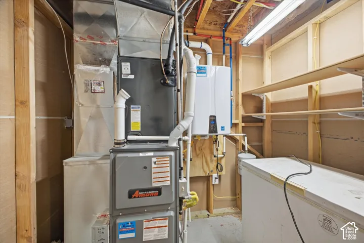 Central HVAC system, tankless water heater, exposed wood framing, and built-in shelving
