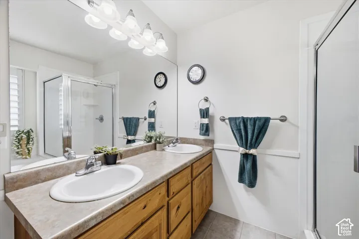 Dual vanity with wood-finish cabinetry, integrated sinks, and polished chrome faucets