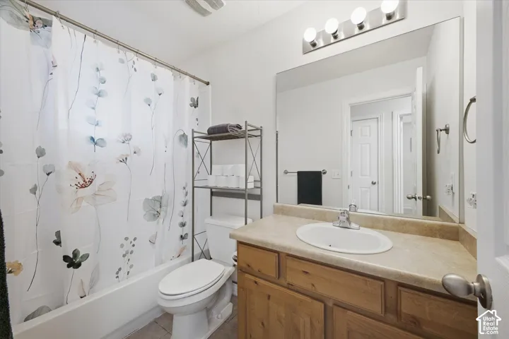 Vanity with an integrated oval sink, wood-finish cabinetry, and a full-width mirror