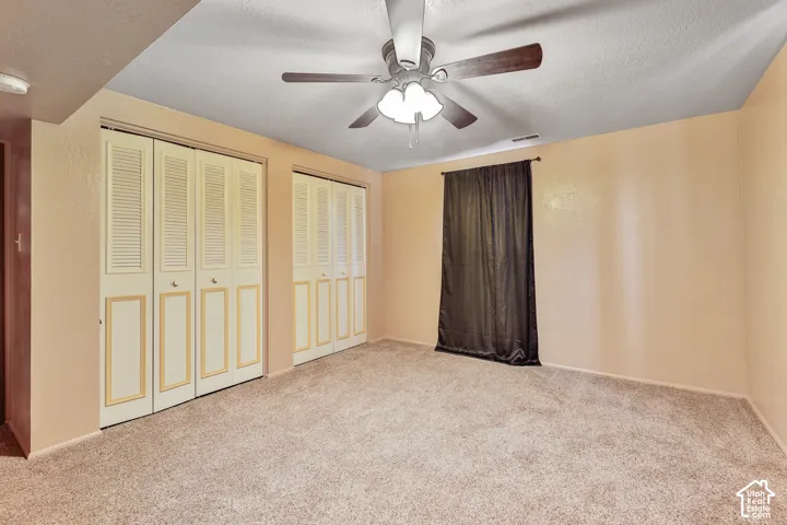 Textured wall surfaces, two bi-fold louvered closet doors, and recessed ceiling lighting