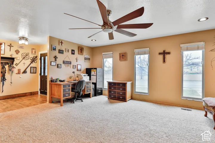 Recessed lighting, ceiling fan, carpet flooring, wood-finish flooring, and multiple windows