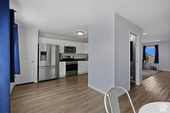 The kitchen offers stainless steel appliances, white shaker cabinetry and floor to ceiling pantry