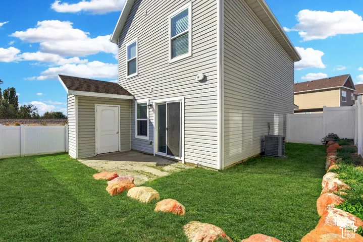 Fully fenced backyard with attached storage shed. Landscaping inside of the fence is maintained by the HOA