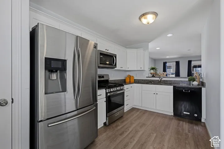 The kitchen offers stainless steel appliances, white shaker cabinetry and floor to ceiling pantry