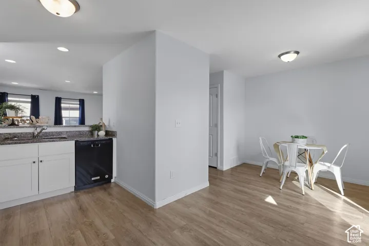 The kitchen offers stainless steel appliances, white shaker cabinetry, dining area and floor to ceiling pantry