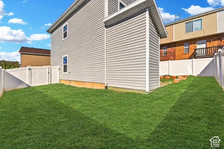 Fully fenced backyard with attached storage shed. Landscaping inside of the fence is maintained by the HOA