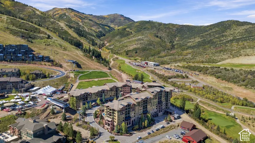 Large multi-story building featuring extensive mountain terrain in the background