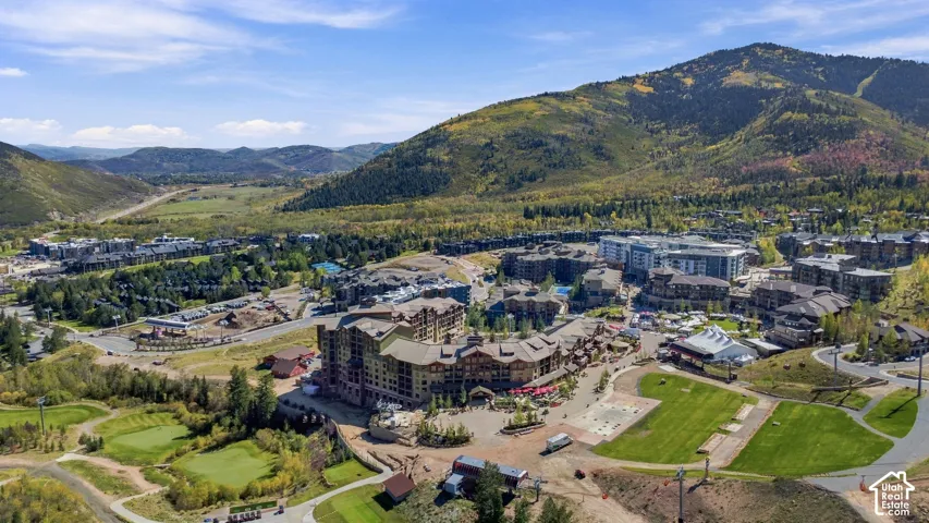 Mountainous landscape with developed properties, extensive green spaces, and a golf course