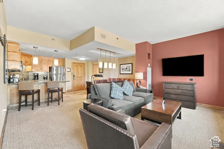 Open-concept living area featuring a kitchen, dining area, and living room
