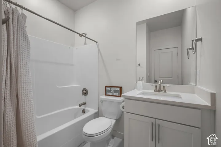 White vanity with shaker-style cabinetry, an integrated sink, and brushed nickel fixtures