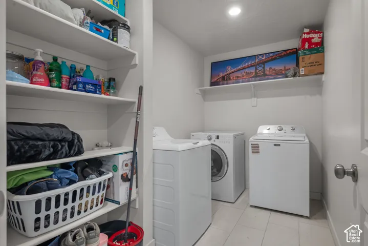 White built-in shelving, recessed ceiling lighting, and tiled flooring