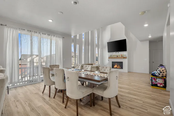 Wood-finish flooring, recessed lighting, and a built-in fireplace with a wood mantle