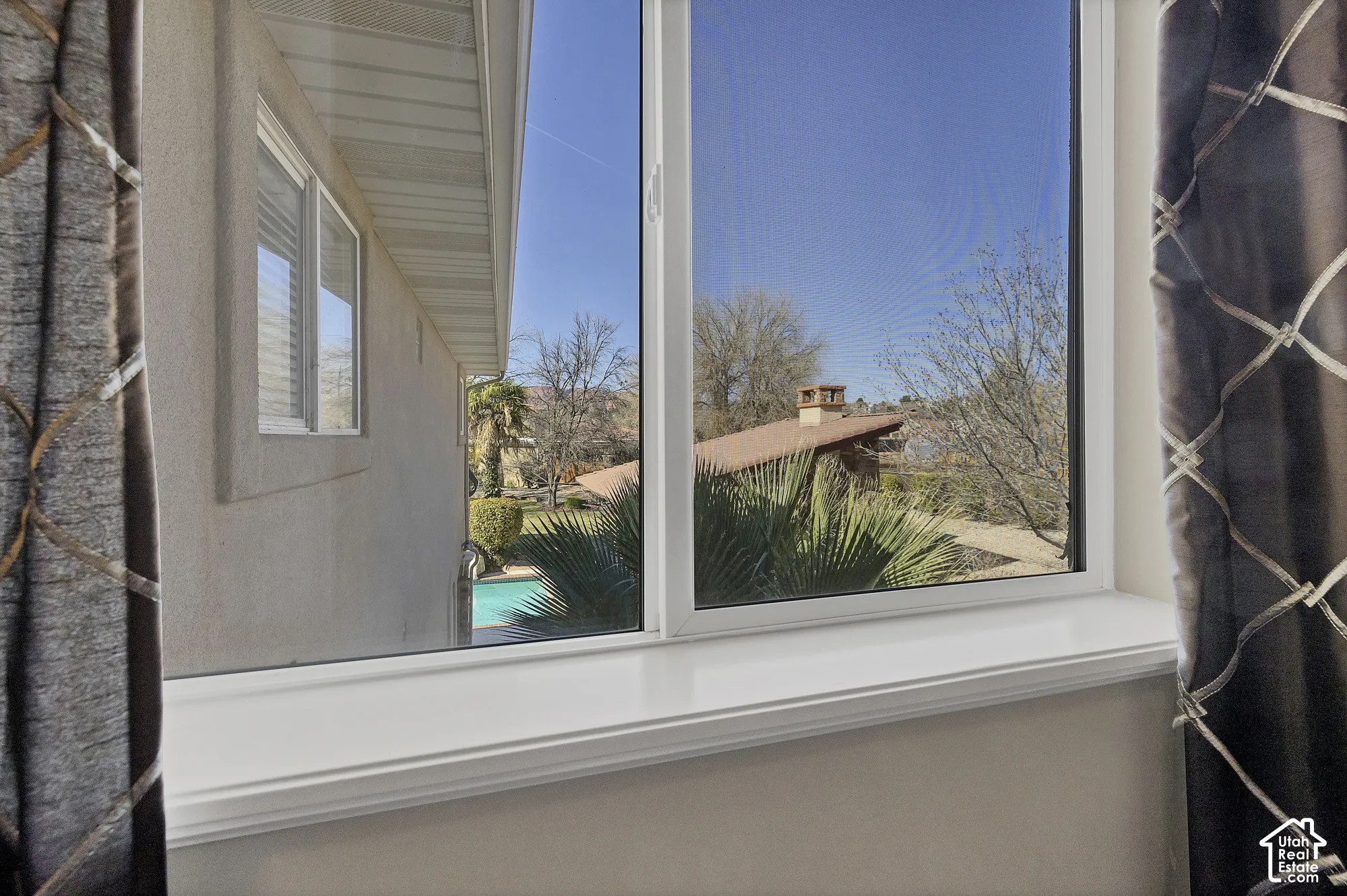 White-framed windows with a substantial sill and detailed trim