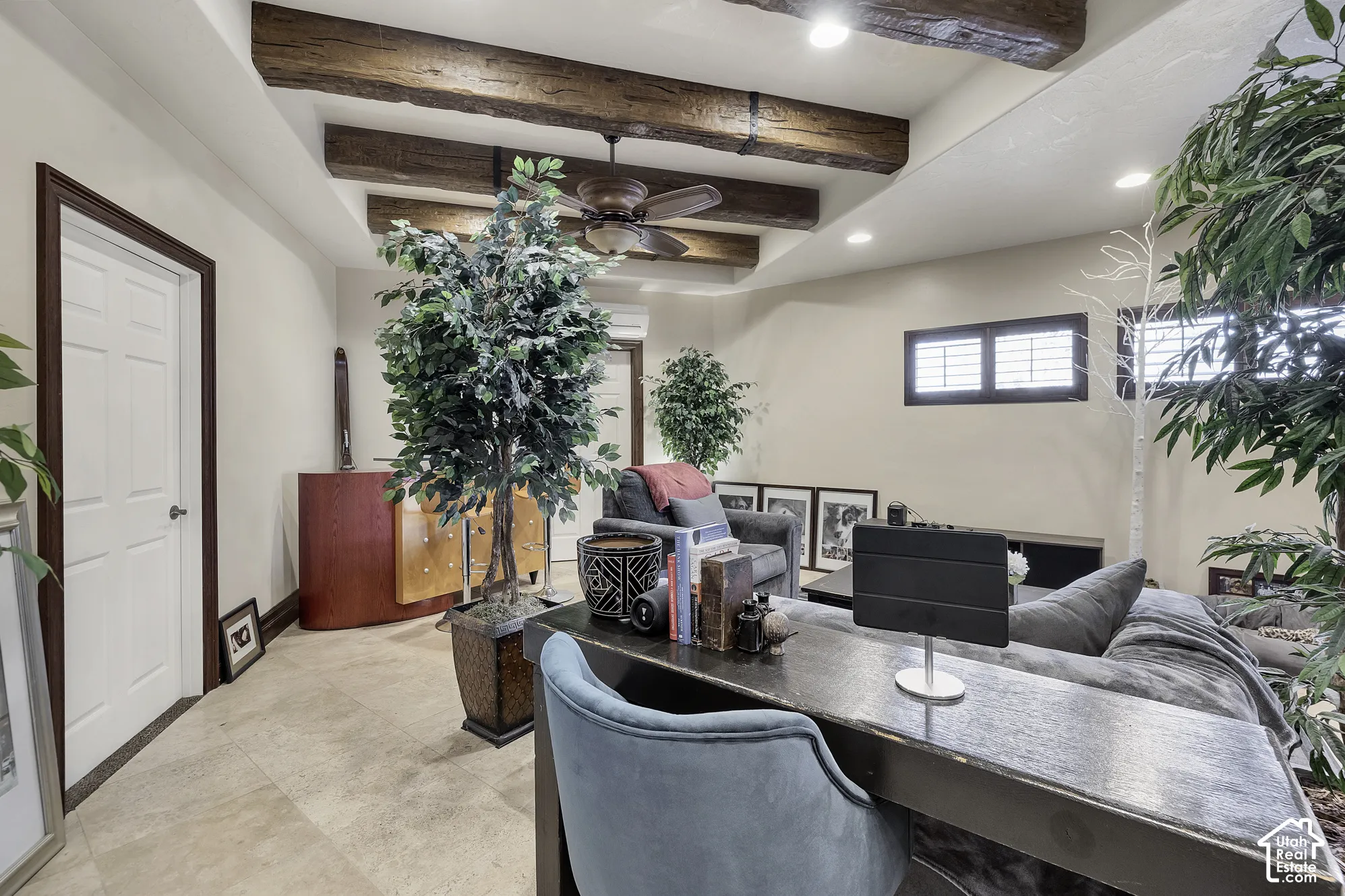 Exposed wood ceiling beams, recessed lighting, ceiling fan, and light-colored tile flooring