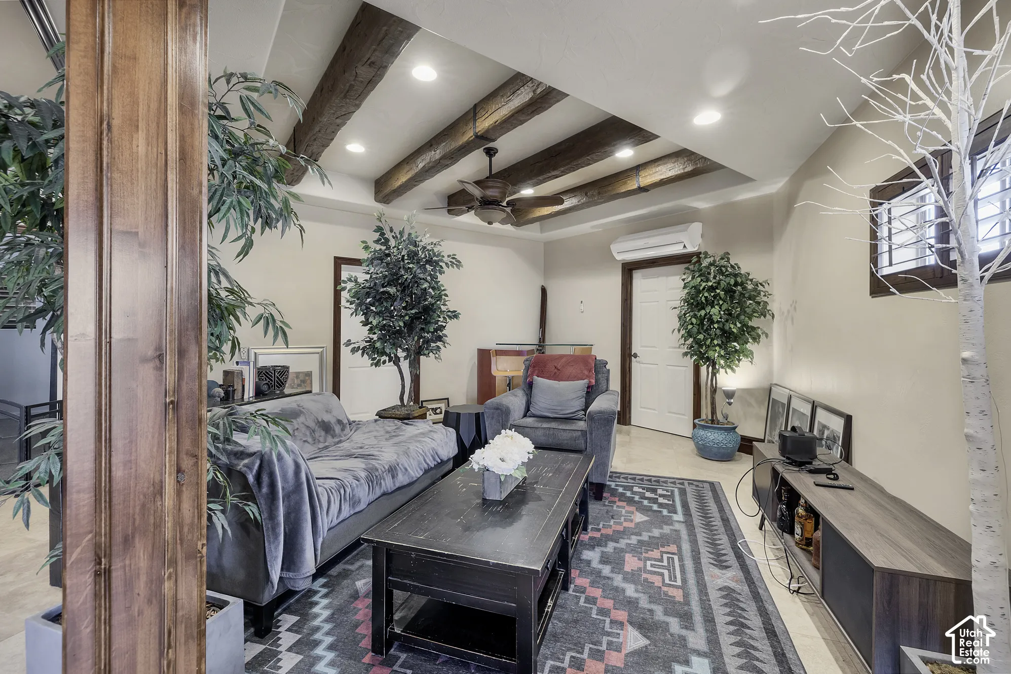 Vaulted ceiling with exposed wood beams, recessed lighting, and a ceiling fan