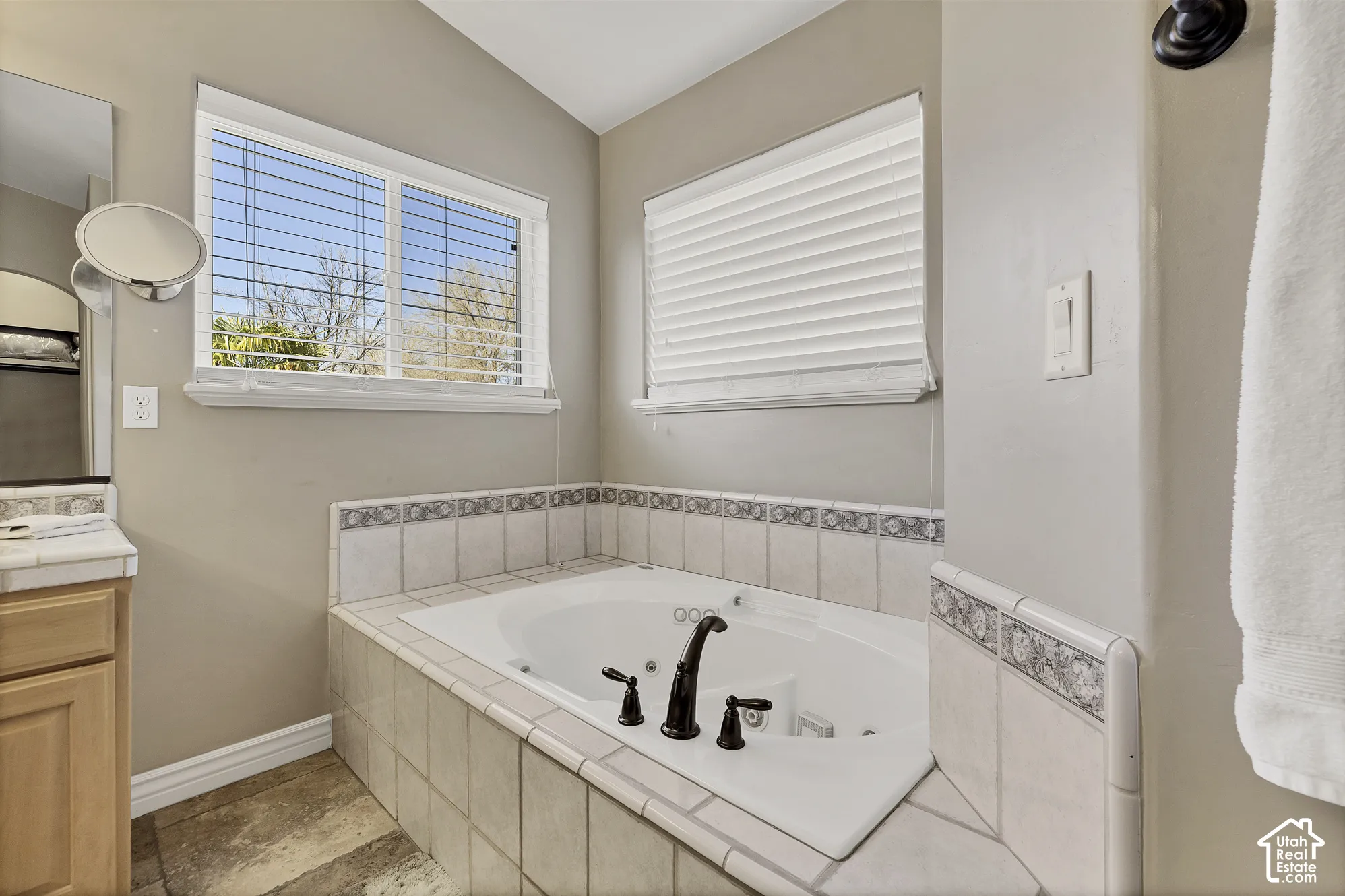 Jetted soaking tub with decorative tile surround and oil-rubbed bronze fixtures
