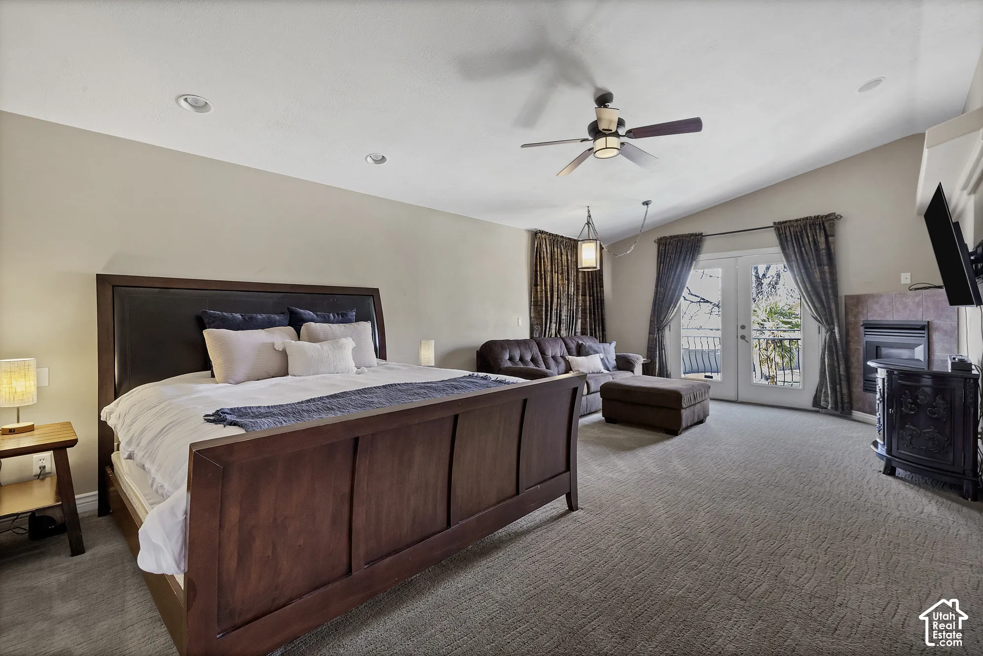 Vaulted ceiling with a ceiling fan, recessed lighting, and a built-in fireplace