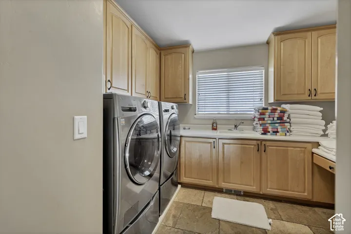 Wood cabinetry, white countertop, integrated sink, and tiled flooring