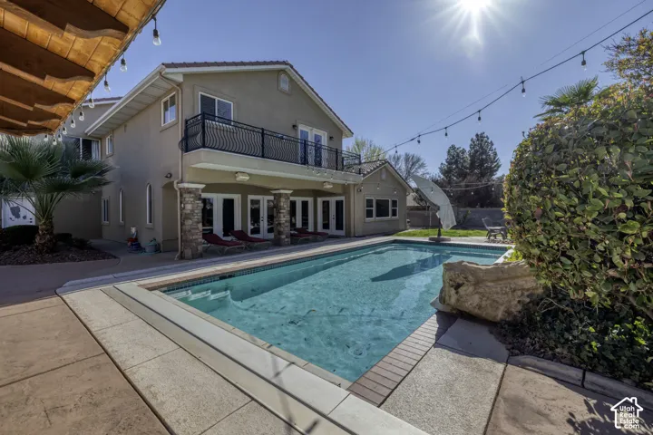 Expansive inground pool with surrounding hardscaping
