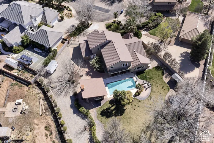 Exterior with a pool, adjacent pool house, and landscaped surroundings