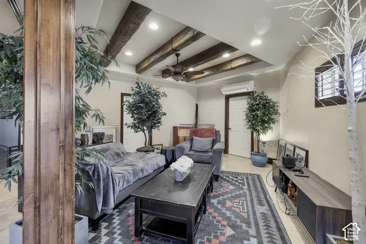 Vaulted ceiling with exposed wood beams, recessed lighting, and a ceiling fan