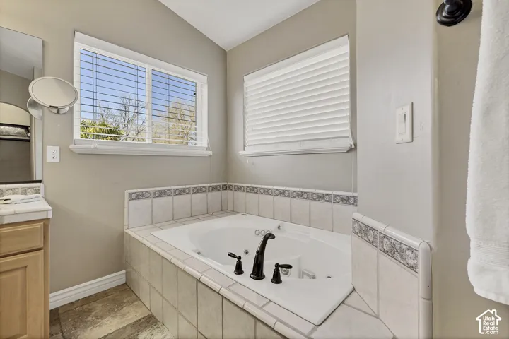 Jetted soaking tub with decorative tile surround and oil-rubbed bronze fixtures