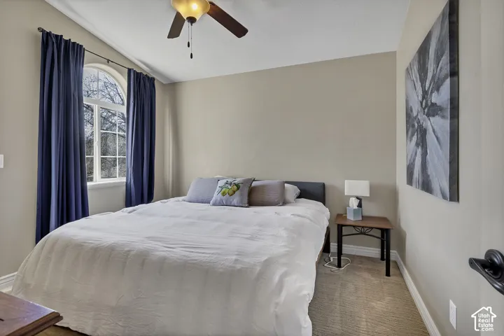 Tray ceiling featuring a ceiling fan with integrated lighting