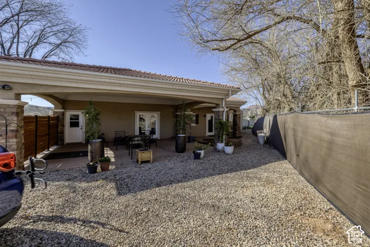 Covered patio with stucco finish and arched entry