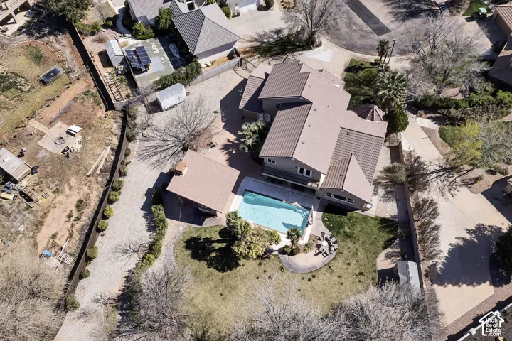 Multi-level residence featuring a swimming pool, patio area, and expansive lawn