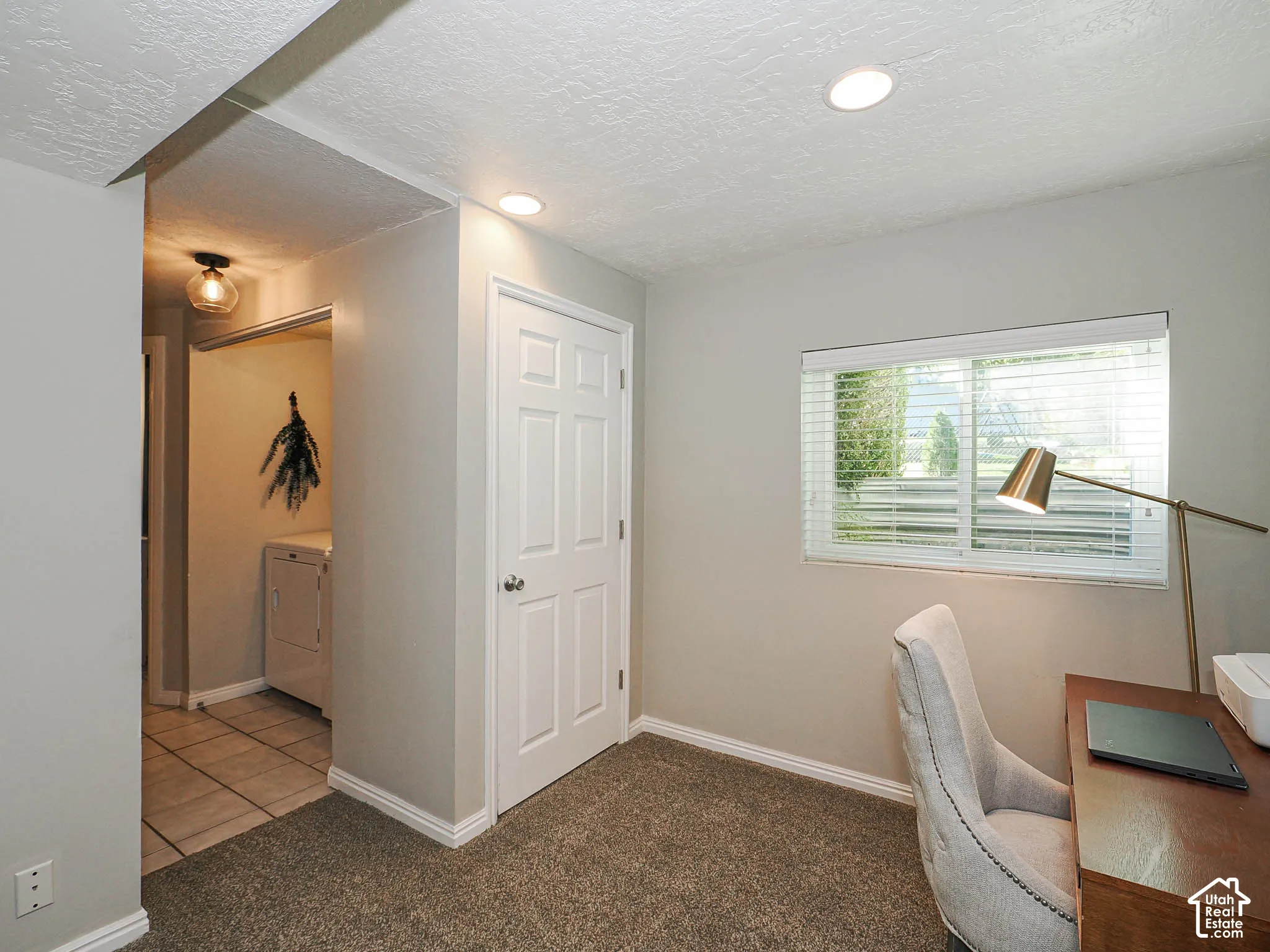 Recessed ceiling lighting, carpet flooring, and a window with blinds