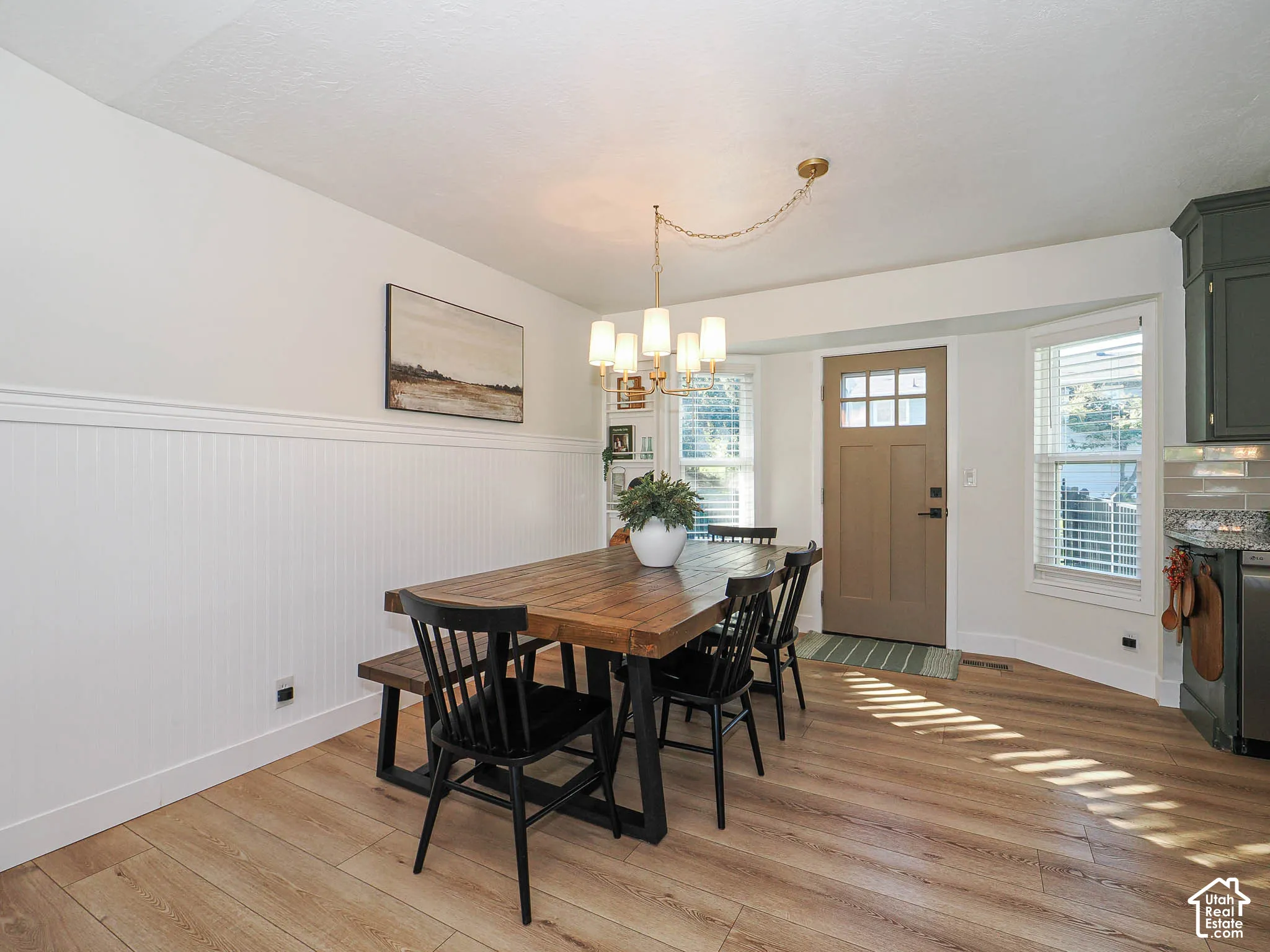 Wood-finish flooring throughout, complemented by white wainscoting and trim