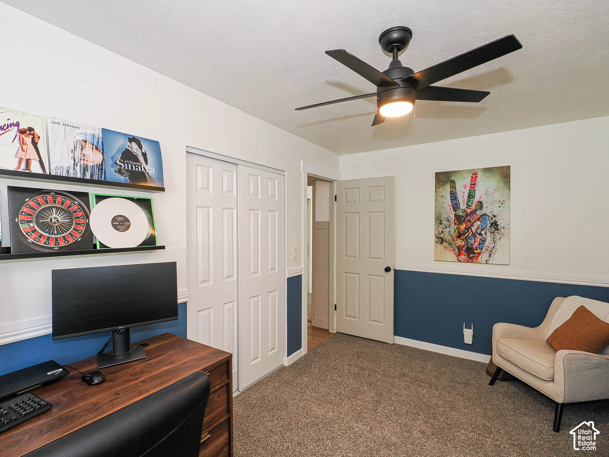 Wall-to-wall carpeting, two-tone wall paint, a six-panel interior door, and a built-in closet with bi-fold doors