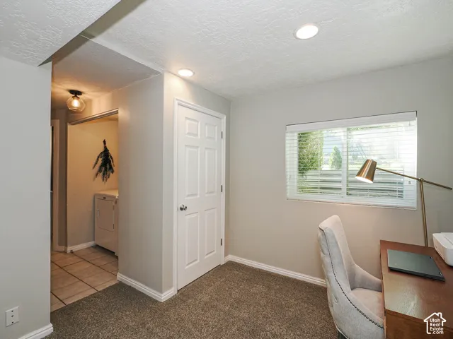 Recessed ceiling lighting, carpet flooring, and a window with blinds