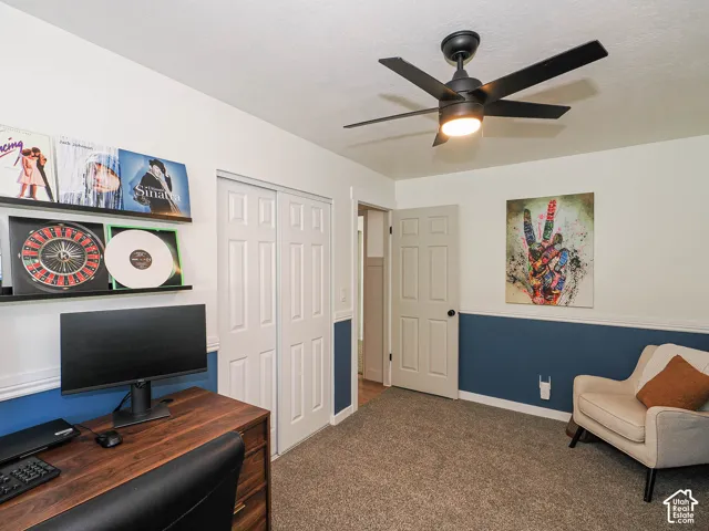 Wall-to-wall carpeting, two-tone wall paint, a six-panel interior door, and a built-in closet with bi-fold doors