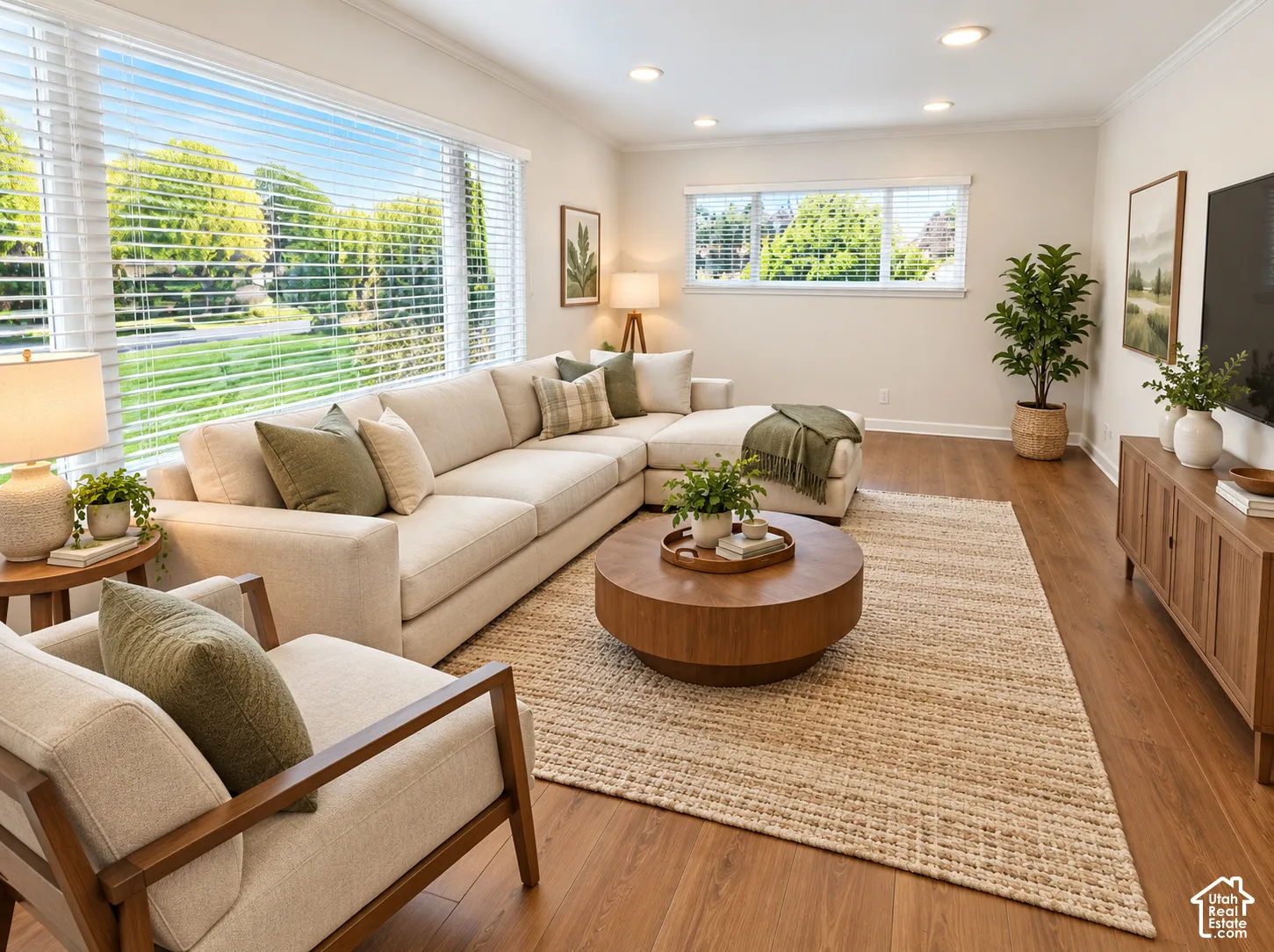 Living area featuring wood-finish flooring, recessed lighting, and expansive windows with horizontal blinds