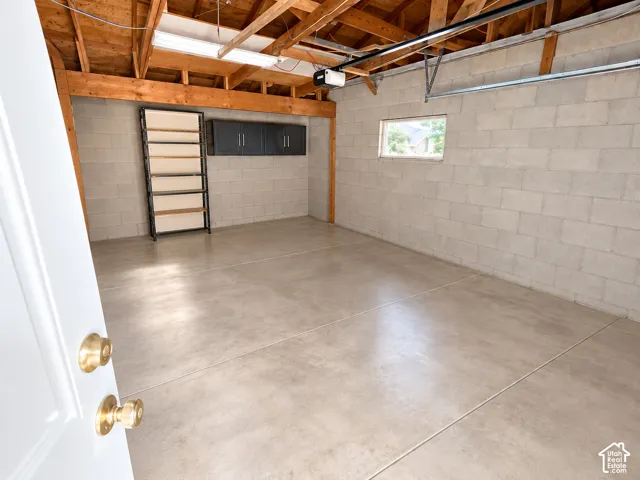 Concrete flooring with exposed ceiling beams and block walls